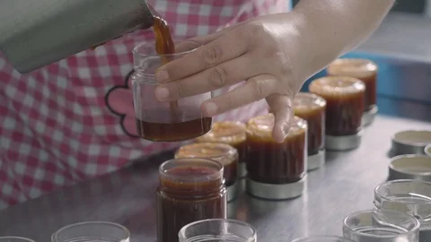 Filling small jars of homemade jam Stock Footage 129993341