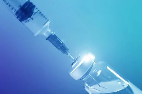Filling syringe with medicine from vial on blue background, closeup Stock Photos