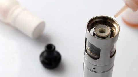 Filling the tank of an electronic cigarette with liquid Stock Footage 158921046