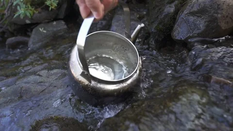 Filling Tea Kettle With Water From River Stream Colorado Video stock 122102288