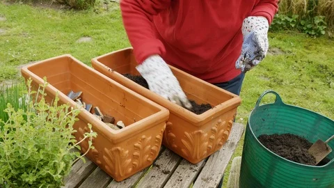 Filling a terracotta container with soil Stock Footage 88744664