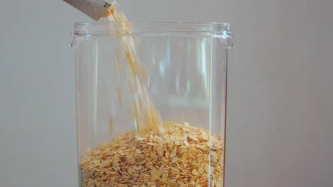 Filling a transparent container with oatmeal Stock-Footage 148293830