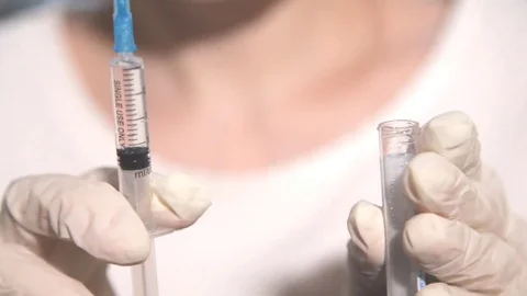 Filling tubes from a syringe by a medic Stock-Footage 72681872