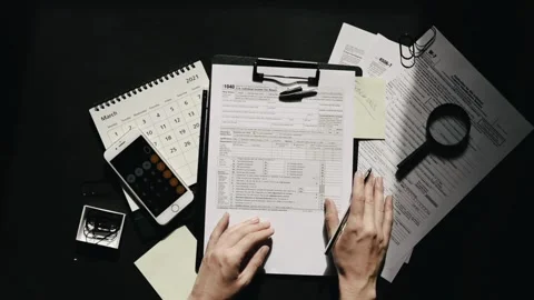 Filling US tax form papers Individual Income Tax Return calculator. closeup.. Stock Footage 272782243