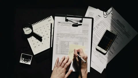 Filling US tax form papers Individual Income Tax Return calculator. closeup.. Stock Footage 272783121