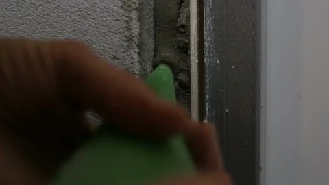 Filling the wall gap with cement mortar from sac a poche, squeezing the gray vis Stock Footage 130928066