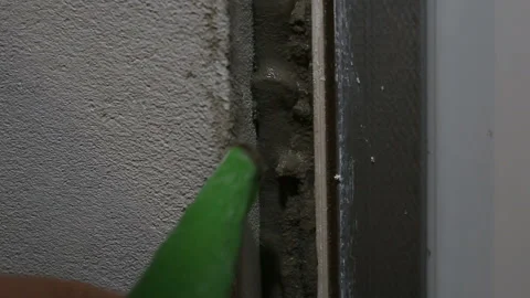 Filling the wall gap with cement mortar from sac a poche, squeezing the gray vis Stock Footage 130928099