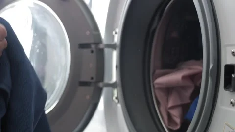 Filling Washing Machine With Multi Colored Dirty Clothes And Garments Stock Footage 250965201