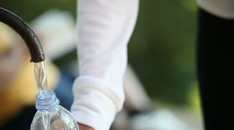 Filling water bottle at park Stock Footage 11133201