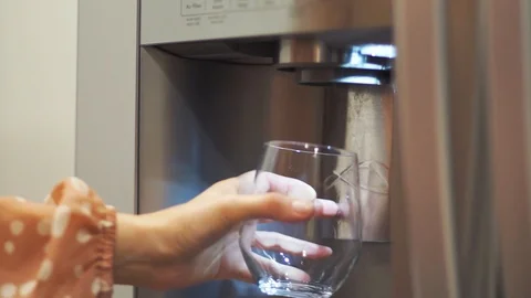 Filling up the water into the cup Stock Footage 94981917