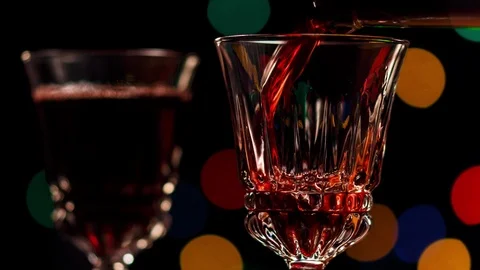 Filling wine glasses, close-up on dark background with blurred lights Stock Footage 100975495