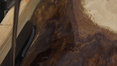 Filling the wood slab with dark epoxy resin. Video stock 183696315