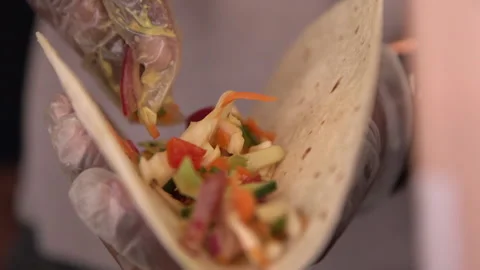 Filling a wrap with salad. Stock-Footage 137955569