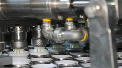 Filling yogurt in plastic cups Video stock 33849586