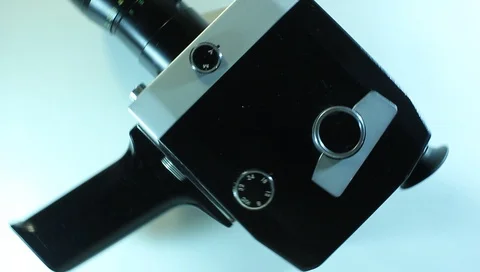 Film camera in motion on a light background, retro style Vídeo Stock 90642726