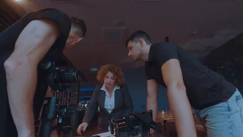 The film crew discusses the script Stock Footage 218396645