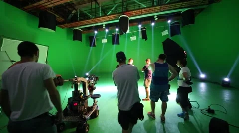 Film crew in green studio talking to each other on shooting video Stock Footage 62370659
