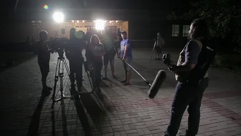 The film crew is interviewing full men night Stock-Footage 71944964
