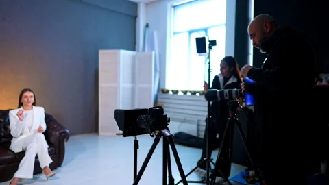 Film Crew Preparing Interview Recording In Studio. Film crew sets cameras and Stock Footage 334812860