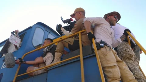 The film crew rides on the train car. Extreme shooting . Movie production Stock Footage 234309313