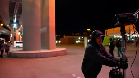 Film crew works under city transport bridge at night Stock Footage 303112839
