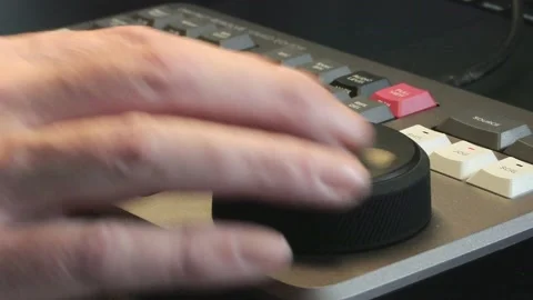 Film Editor Using Professional Editing Console in Low-Lit Studio Stock Footage 348125921