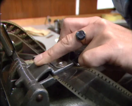 Film editor at work  - editing, pasting a film using a film splicer Stock Footage 39675011