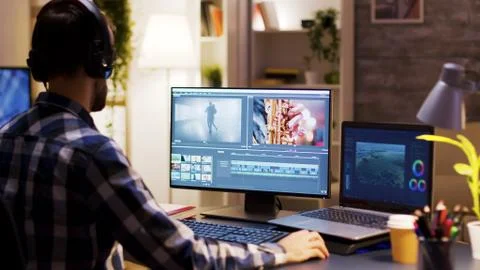 Film maker pointing at the monitor in home office Stock Photos