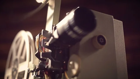 Film projector on a black background with dramatic lighting and selective focus. Stock Footage 95903611