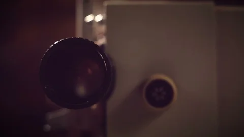 Film projector on a black background with dramatic lighting and selective focus. Stockbeeldmateriaal 95905771