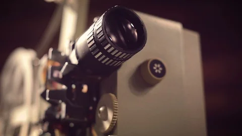 Film projector on a black background with dramatic lighting and selective focus. Видео 97919062
