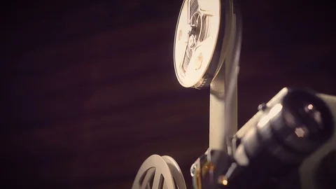 Film projector on a black background with dramatic lighting and selective focus. 動画素材 97919276