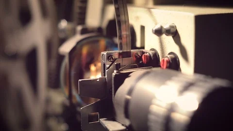 Film projector on a black background with dramatic lighting and selective focus. Vídeo Stock 97920460
