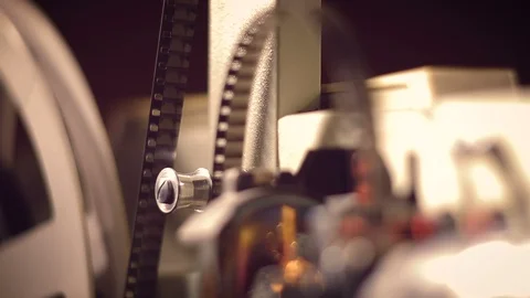 Film projector on a black background with dramatic lighting and selective focus. Vídeo Stock 97921020