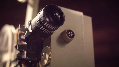 Film projector on a black background with dramatic lighting and selective focus. Stock Footage 100173004