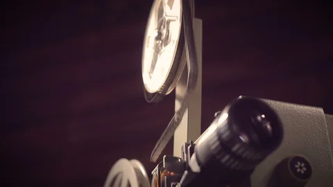 Film projector on a black background with dramatic lighting and selective focus. Stock Footage 100173279