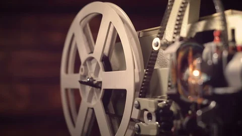 Film projector on a black background with dramatic lighting and selective focus. Stock Footage 100173522