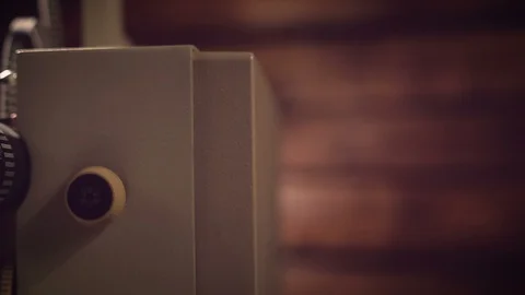 Film projector on a black background with dramatic lighting and selective focus. Stock Footage 100173654