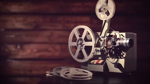 Film projector on a black background with dramatic lighting and selective focus. Stock Footage 100174117