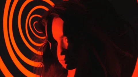 Film of psychedelic red circles projected onto face of female model. Stock Footage 77581961