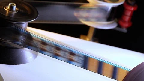 Film runs through a 35mm projector in a movie theater Stock Footage 93583360