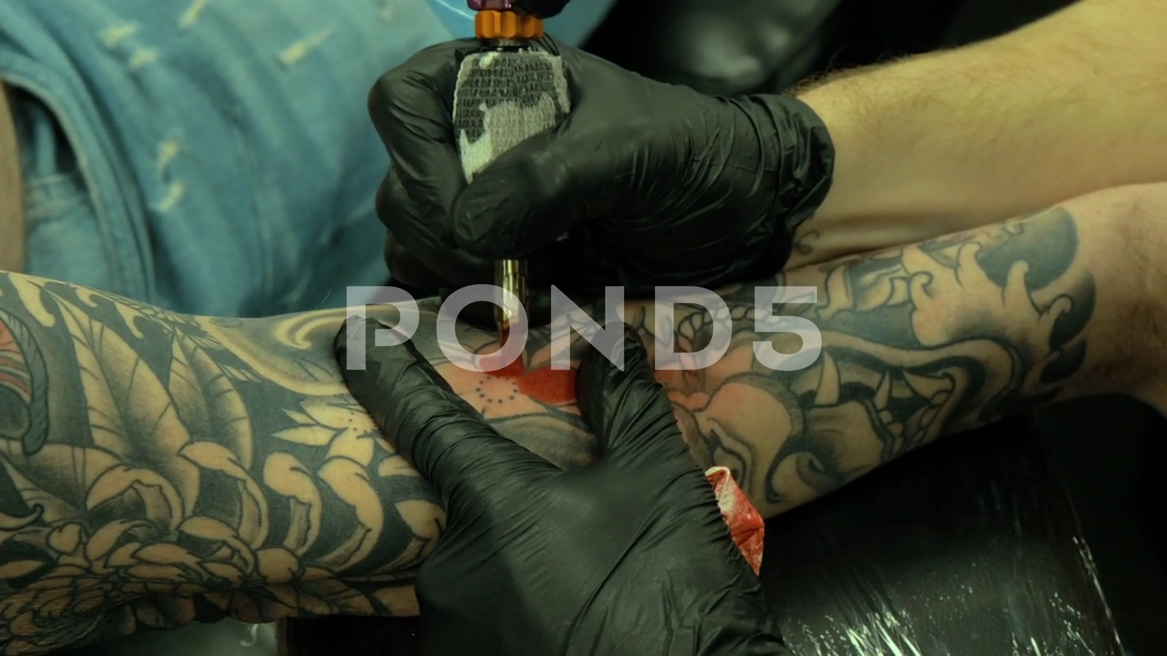 tattoo artist shaving mans knee for tattoo  Slow Motion  ClipStock