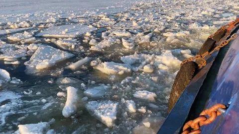 Filming from aboard a river tug. Broken pieces of ice on the river. Spring ice Stock Footage 252643396