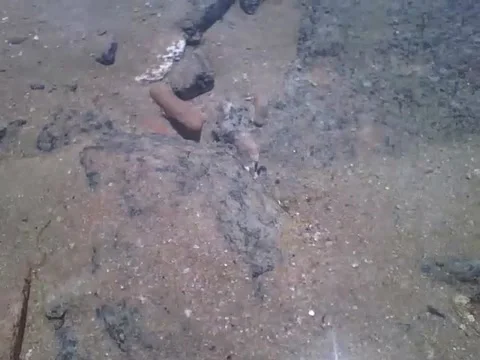 Filming between the rocks of beach, you can see the crystal clear water! Video stock 166428468