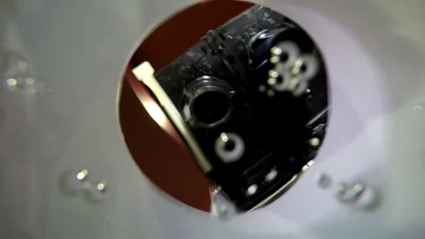 Filming inside plastic cup filled with soda water drink with bubbles young man p Stock Footage 137540141