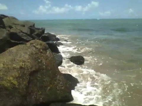 Filming the ocean waves hitting the rocks near the beach Stock Footage 163683659