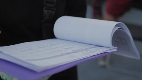 Filming staff checks script for scene for upcoming film Stock Footage 231858779