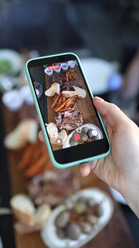 Filming steak dinner on phone Stock Footage 334521389