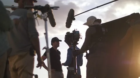 Filming in the steppe. The operator moves the camera along the slider. Film crew Stock Footage 226922973