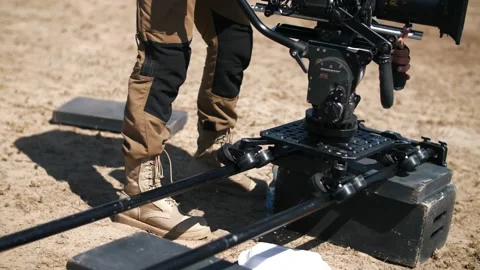 Filming in the steppe. The operator moves the video camera along the slider. Stock Footage 226583272